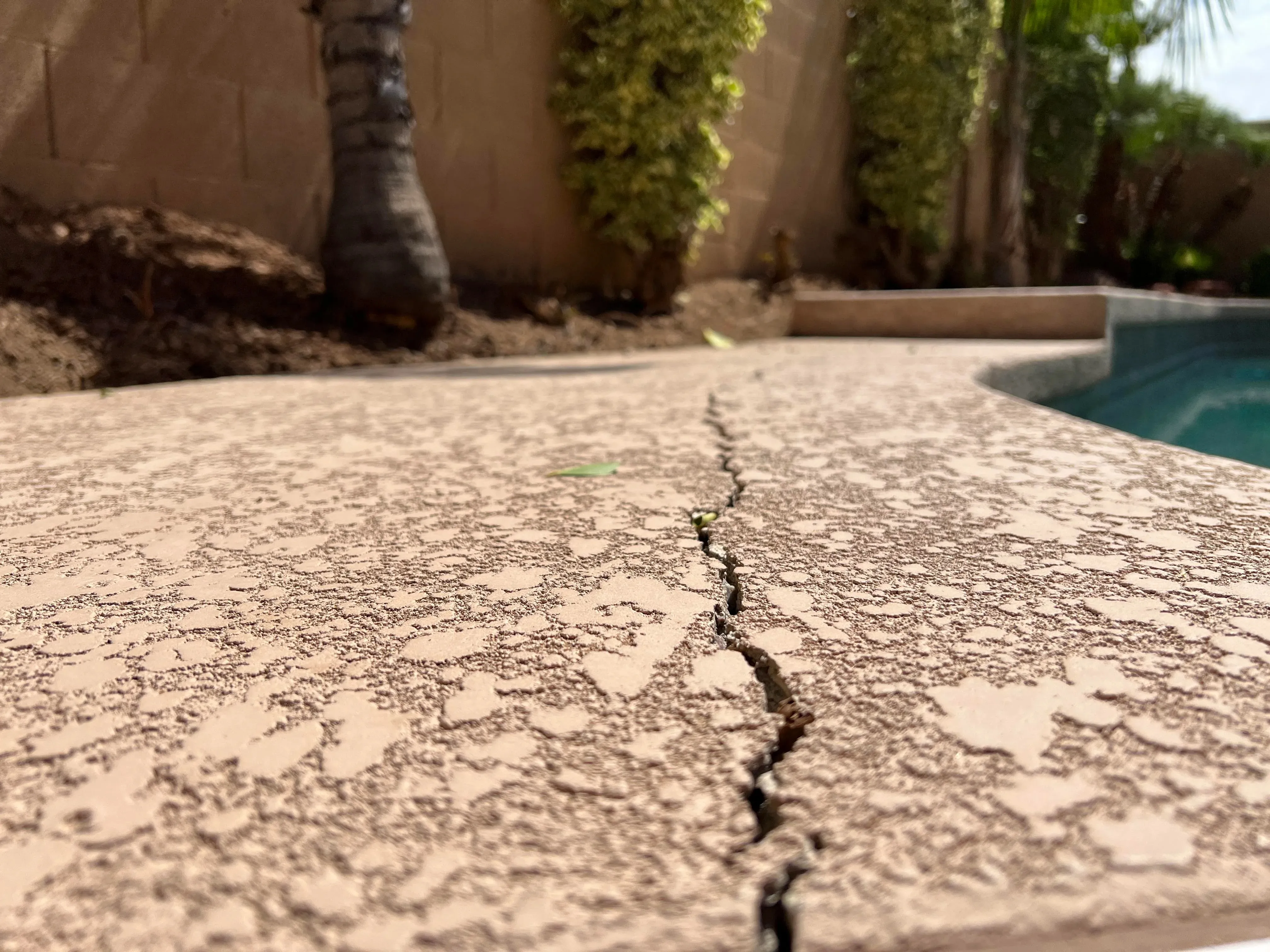 Technician resurfacing a concrete patio