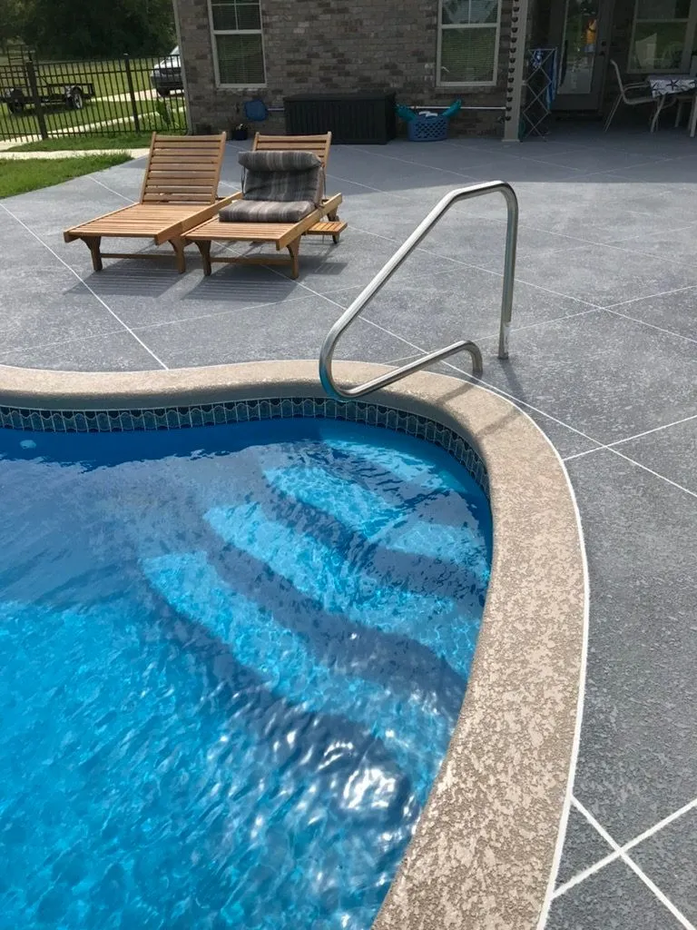 beige and gray concrete kool deck pool surface with control joints