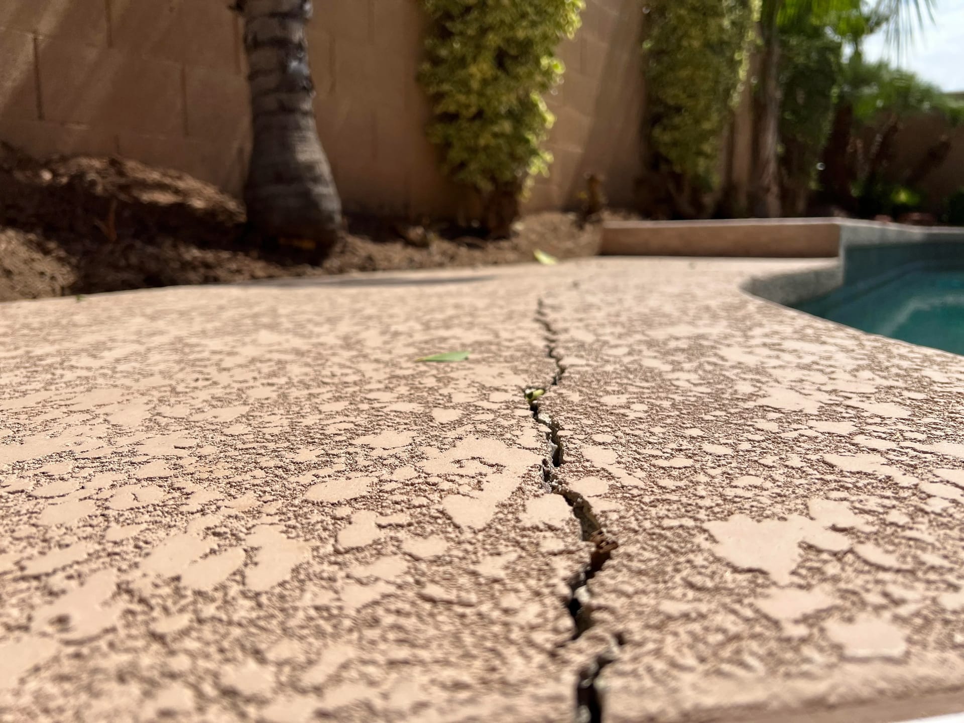 Technician resurfacing a concrete patio